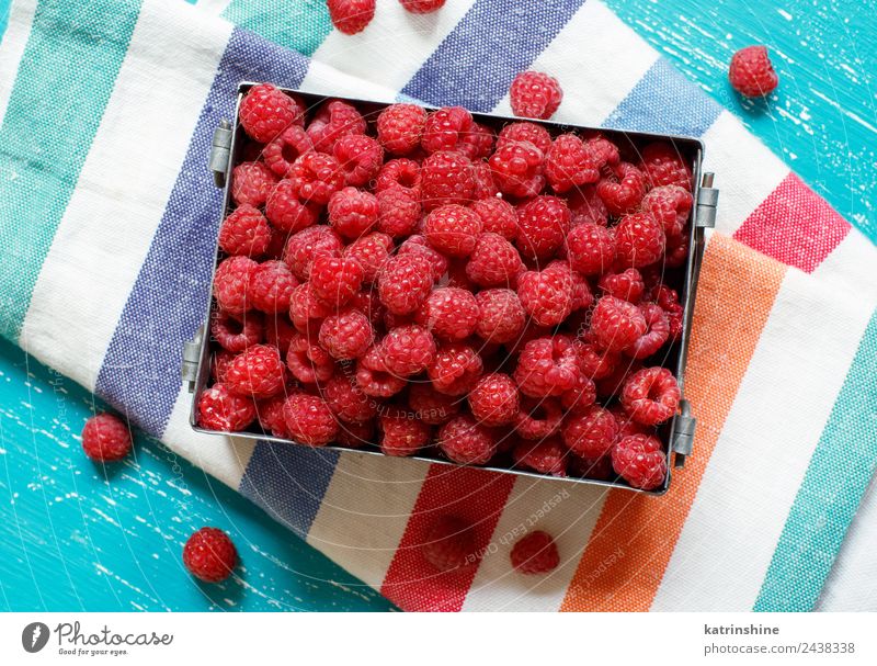 Fresh raspberries in a metal box Fruit Dessert Nutrition Breakfast Vegetarian diet Diet Summer Natural Blue Pink Red Turquoise background Berries colorful Detox