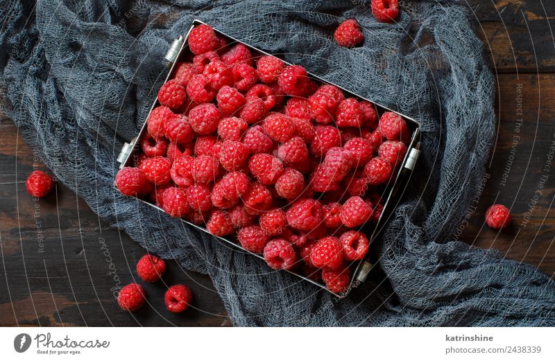 Fresh raspberries in a metal box Fruit Dessert Nutrition Breakfast Vegetarian diet Diet Summer Dark Natural Pink Red background Berries colorful Detox food