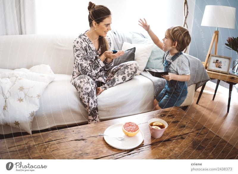 happy little boy giving gift to mother at home in living room Fruit Tea Lifestyle Happy Beautiful Relaxation Playing Table Child Toddler Boy (child) Woman