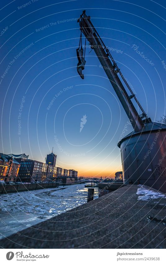 Hamburg crane in the Speicherstadt in winter Europe Germany Old warehouse district World heritage Harbour Night Night shot Wide angle Clouds Sunset Handrail