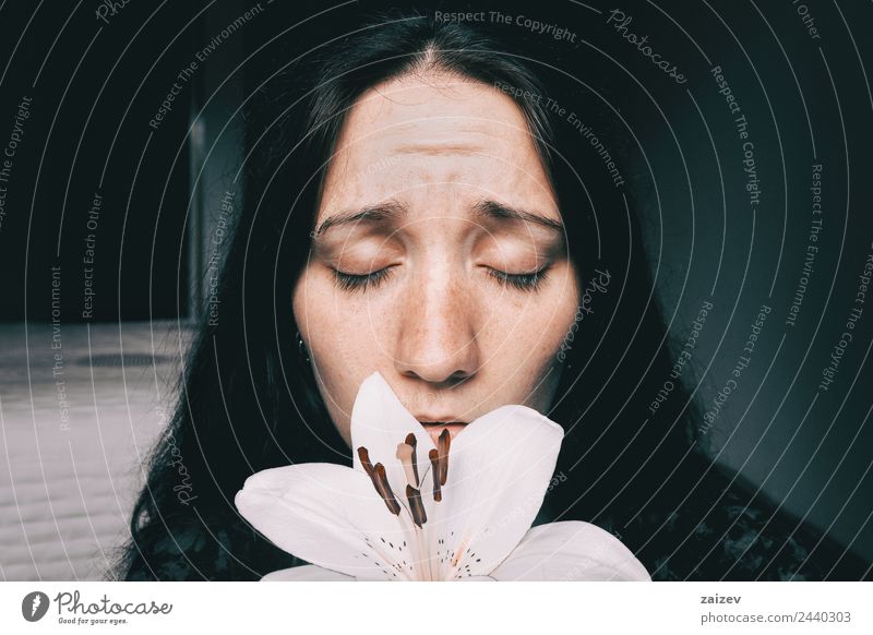 a girl with a white lily and eyes closed worried Lifestyle Beautiful Face Relaxation Calm Human being Feminine Young woman Youth (Young adults) Woman Adults 1