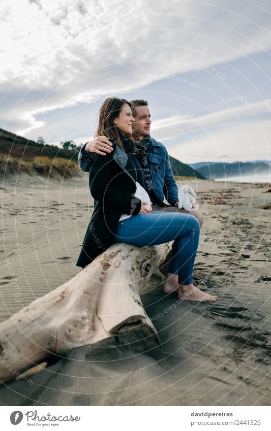 Pregnant on the beach with her partner Lifestyle Happy Beach Ocean Winter Human being Woman Adults Man Mother Father Couple Partner Feet Sand Autumn Coat