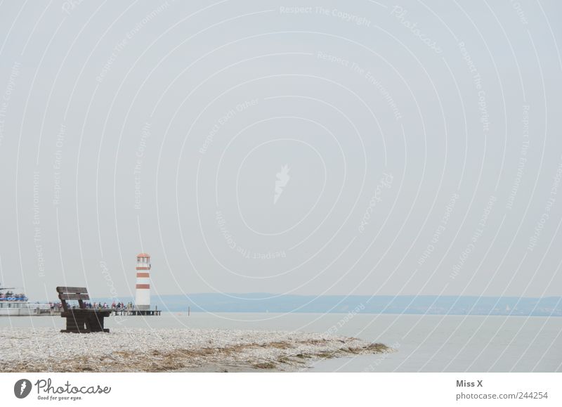 solitary Vacation & Travel Tourism Beach Environment Landscape Sand Weather Bad weather Fog Coast Lakeside Ocean Island Cold Park bench Lighthouse