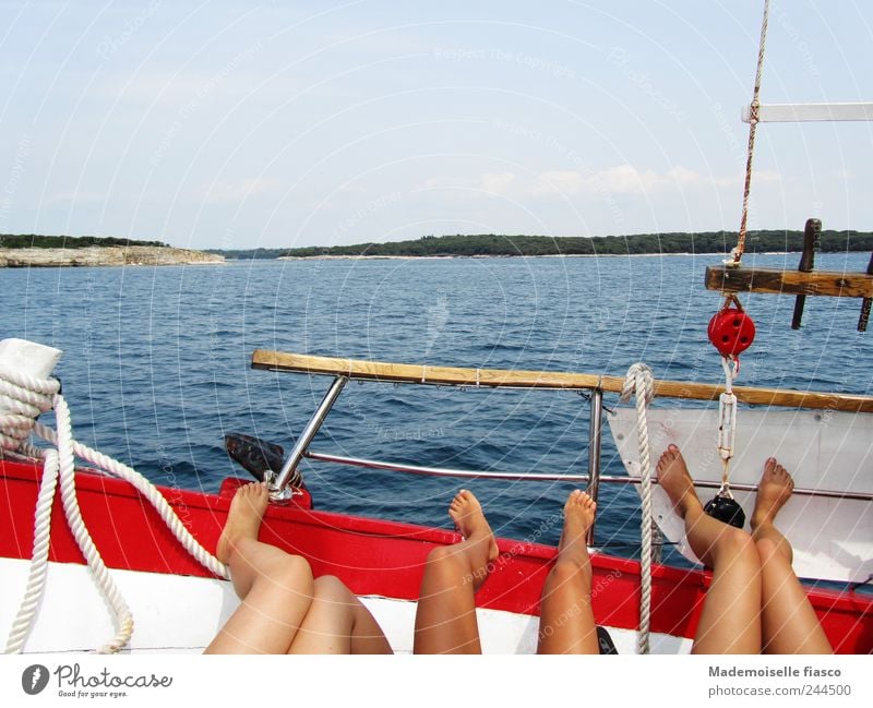 Legs while sunbathing on floating/driving boat near coast Relaxation Trip Ocean Young woman Youth (Young adults) 3 Human being 18 - 30 years Adults Boating trip