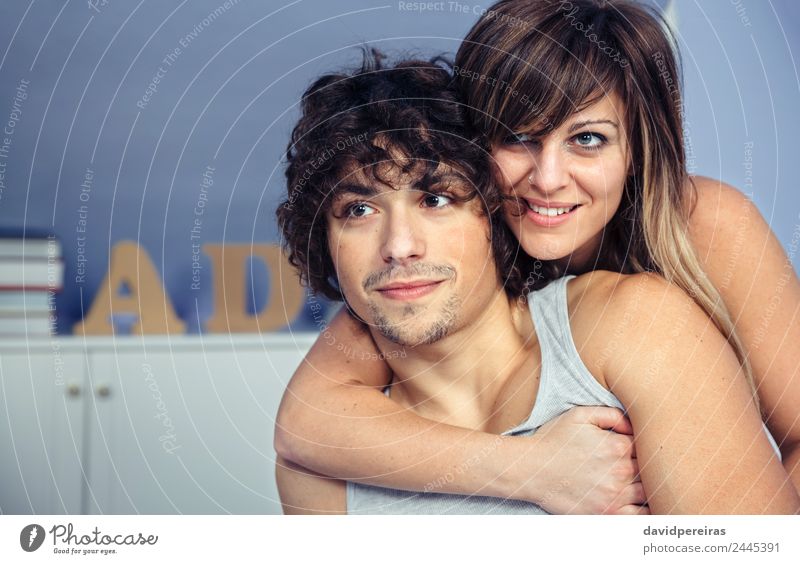 Couple in love embracing and smiling on bedroom Lifestyle Happy Beautiful Relaxation Bedroom Camera Woman Adults Man Family & Relations Smiling Laughter Love