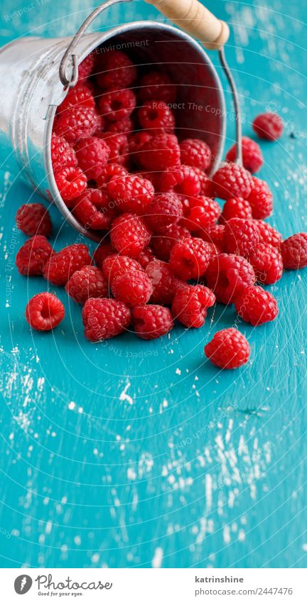 Fresh raspberries in a small metal bucket Fruit Dessert Nutrition Breakfast Vegetarian diet Diet Summer Natural Blue Pink Red Turquoise background Berries