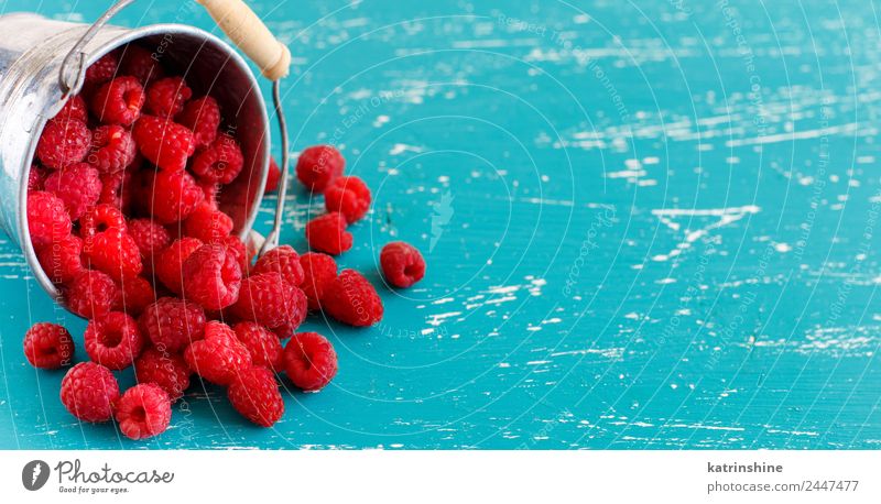 Fresh raspberries in a small metal bucket Fruit Dessert Nutrition Breakfast Vegetarian diet Diet Summer Bright Natural Blue Pink Red Turquoise Colour background