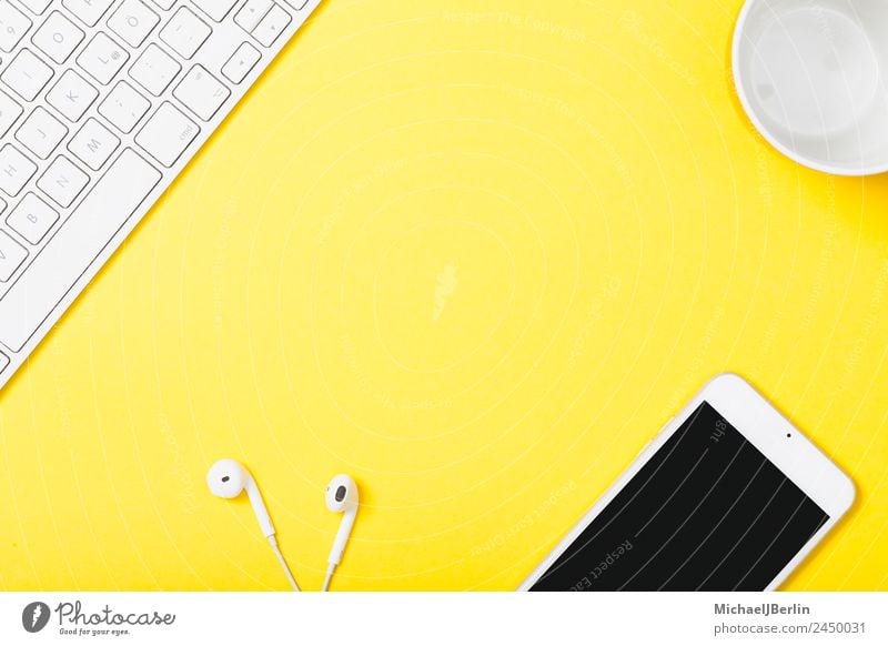 Mobile phone and headphones on yellow background Cup Office Cellphone Keyboard Happiness Yellow Background picture Clever Symbols and metaphors Headphones