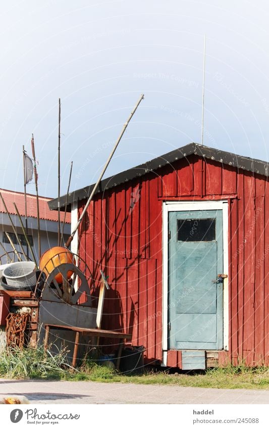 fisherman's hut Tourism Hut Coast Baltic Sea Sweden Fishing village Harbour Door Blue Red Maritime Wooden board Roof Flag Fishery Fishing net Storage Industry