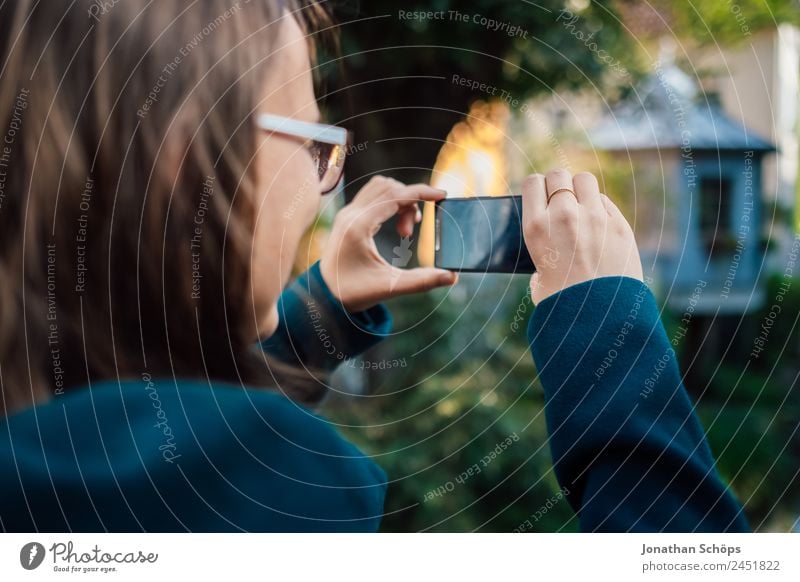 young woman takes a photo with smartphone at a bridge with both hands Lifestyle Style Joy luck Human being Feminine Young woman Youth (Young adults)