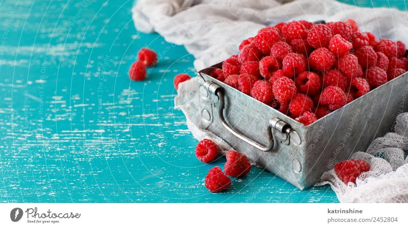 Fresh raspberries in a metal box Fruit Dessert Nutrition Breakfast Vegetarian diet Diet Summer Natural Blue Pink Red Turquoise background Berries colorful Detox