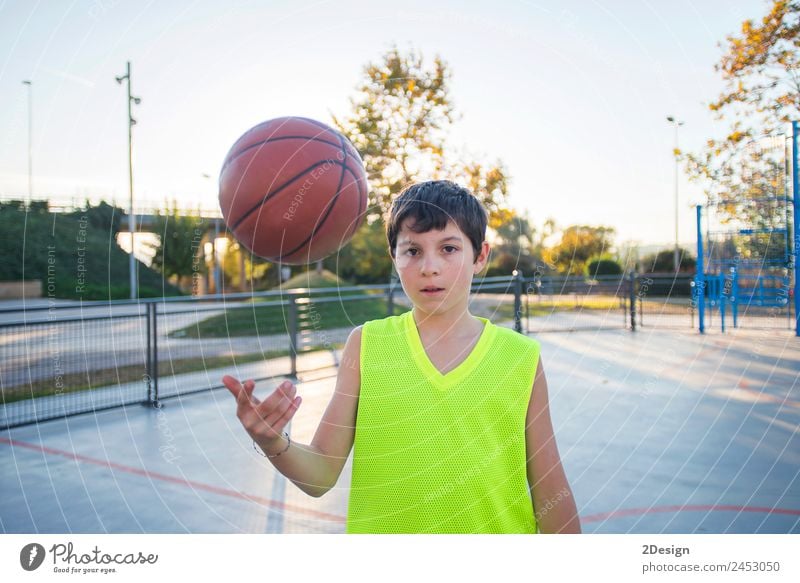 Beautiful young teen model wearing a yellow sleeveless and holding the ball on the court Lifestyle Happy Face Relaxation Leisure and hobbies Playing Sports