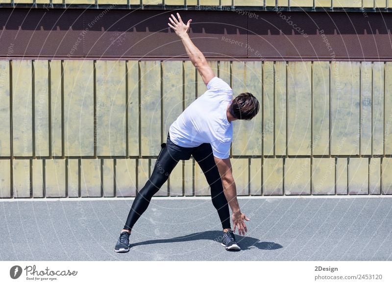 Athletic man warming up before running. Lifestyle Relaxation Leisure and hobbies Summer Sports Jogging Human being Masculine Young man Youth (Young adults) Man