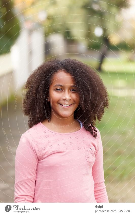 Cute African American girl smiling in the street with afro hair Joy Happy Beautiful Winter Child Human being Toddler Infancy Nature Park Afro Smiling Happiness