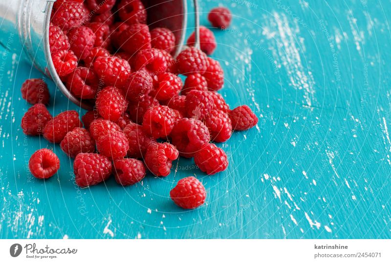 Fresh raspberries in a small metal bucket Fruit Dessert Nutrition Breakfast Vegetarian diet Diet Summer Natural Blue Pink Red Turquoise background Berries