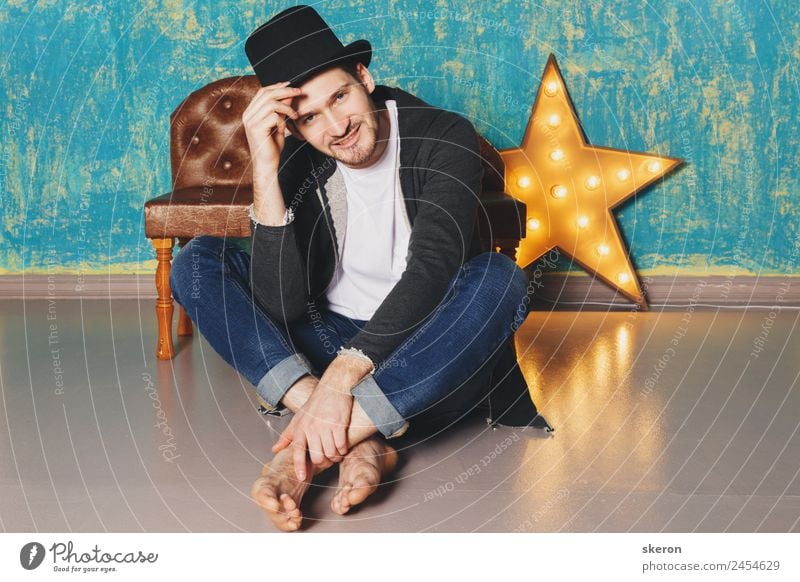 the guy in the hat sitting near the lamp-star Lifestyle Leisure and hobbies Sports Work and employment Profession Masculine Young man Youth (Young adults) 1