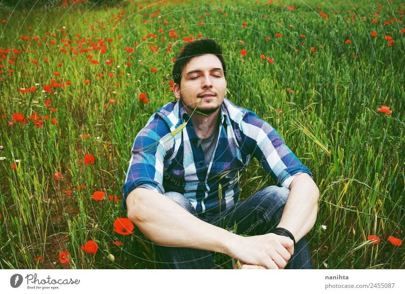 Young man alone in a field of green wheat Lifestyle Style Joy Wellness Senses Relaxation Calm Meditation Agriculture Forestry Human being Masculine