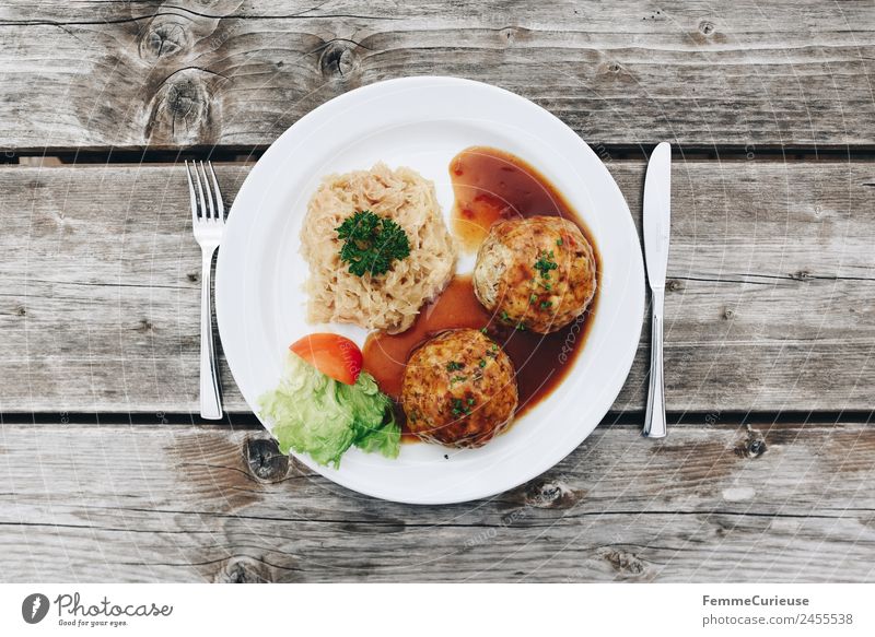 Bacon dumplings with sauerkraut and sauce Food Nutrition Lunch Dinner To enjoy Dumpling Sauce Salad leaf Plate Cutlery Wooden table Bird's-eye view Snack