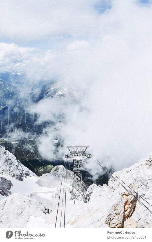 Ropes of a cable car in the alps Nature Clouds Fog Dreary Gondola Ferris wheel Cable car Alps Mountain Sunbeam Pole Colour photo Exterior shot Deserted