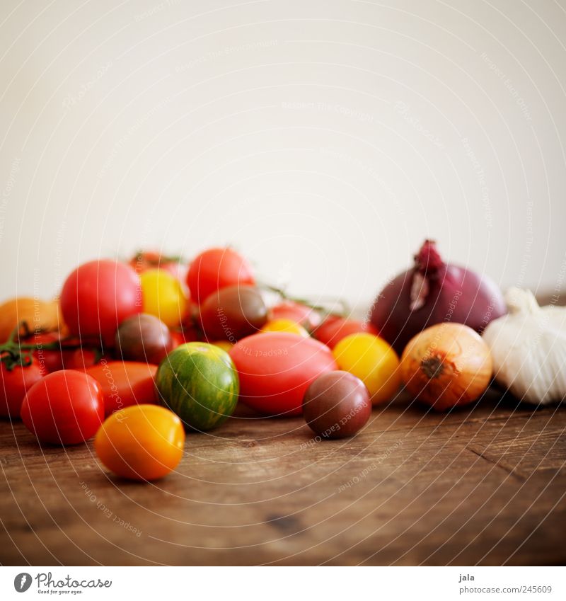 summer vegetables Food Vegetable Tomato Onion Garlic bulb Healthy Delicious Yellow Green Red Wooden table Colour photo Interior shot Deserted Copy Space top