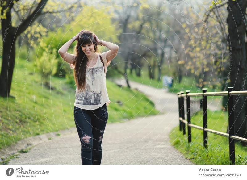 beautiful young woman smiling while walking in the park Lifestyle Joy Happy Beautiful Healthy Well-being Relaxation Vacation & Travel Freedom Summer Human being