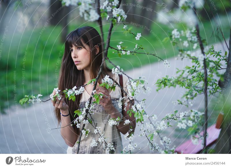 Romantic caucasian girl with long brown hair in a serene pose Lifestyle Beautiful Hair and hairstyles Manicure Healthy Relaxation Calm Woman Nature Spring