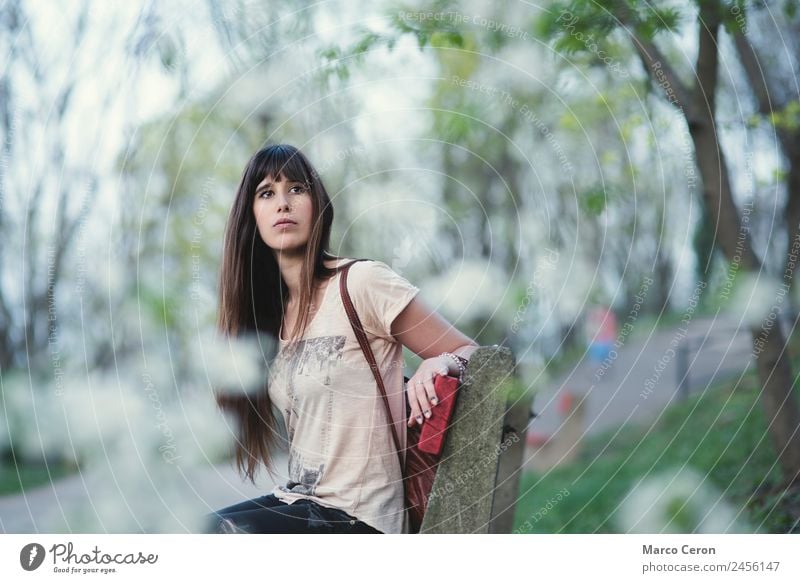 Attractive young woman sitting in a bench in a park Lifestyle Beautiful Hair and hairstyles Nail polish Relaxation Calm Vacation & Travel Summer Human being