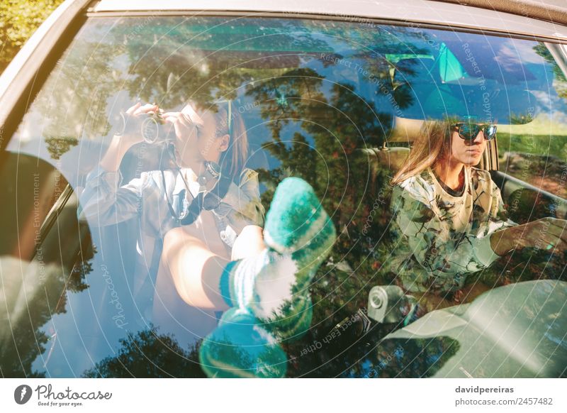 Woman looking through the binoculars and friend driving Lifestyle Happy Beautiful Relaxation Leisure and hobbies Vacation & Travel Trip Human being Adults