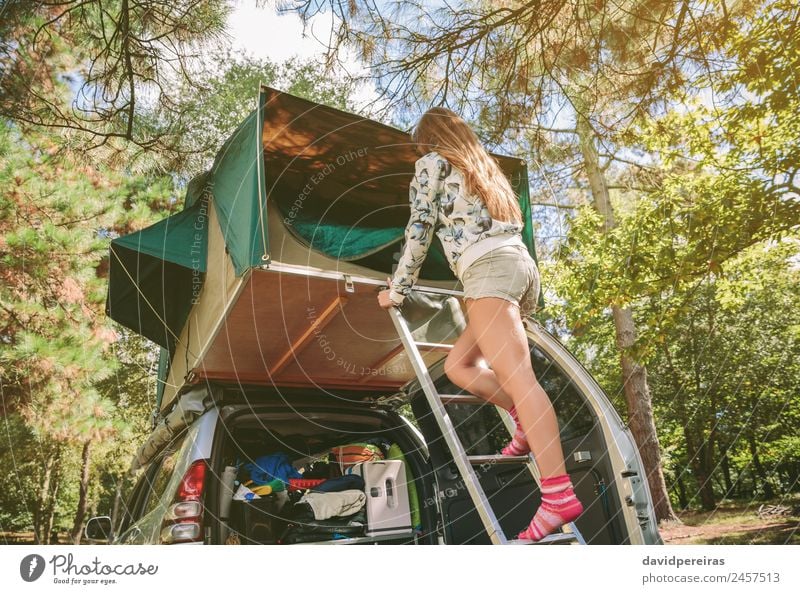 Woman standing in ladder opening tent over car Lifestyle Joy Happy Relaxation Leisure and hobbies Vacation & Travel Trip Adventure Camping Summer Mountain