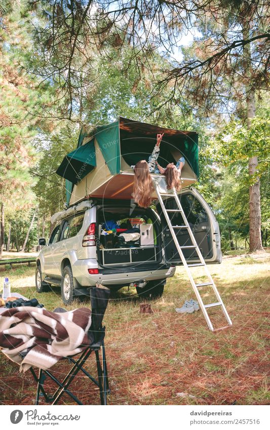 Women resting lying in tent over 4x4 and looking nature Lifestyle Joy Happy Relaxation Leisure and hobbies Vacation & Travel Trip Adventure Camping Summer