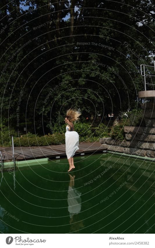 Woman jumps into swimming pool 2 Lifestyle Joy Beautiful Vacation & Travel Tourism Trip Young woman Youth (Young adults) Adults 18 - 30 years Landscape Summer