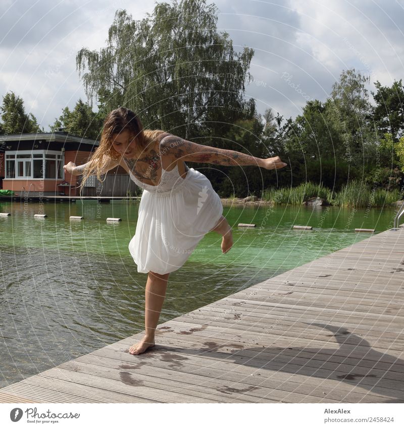 Woman balancing at the swimming pool Lifestyle Joy Beautiful Swimming pool Trip Summer Summer vacation Young woman Youth (Young adults) Adults 18 - 30 years