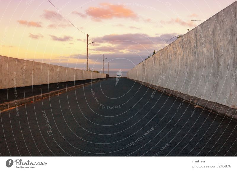 dipped headlamps Sky only Clouds Beautiful weather Small Town Outskirts Skyline Wall (barrier) Wall (building) Transport Passenger traffic Road traffic Motoring