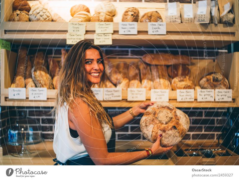 Woman sells in bakery. Bread Shopping Profession Business Human being Adults Smiling Sell Fresh Small Arrangement Retail sector Bread basket Hold Indulgence