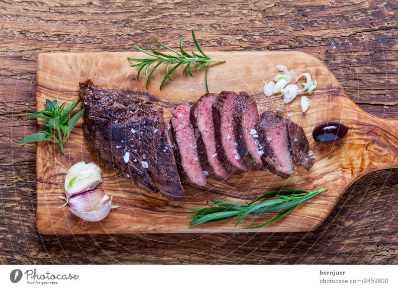 grilled steak on wood Food Meat Herbs and spices Wood Good beef steak steak disc Steak board Chopping board Ribeye cut Cooking Pepper Rosemary Salt grilled meat