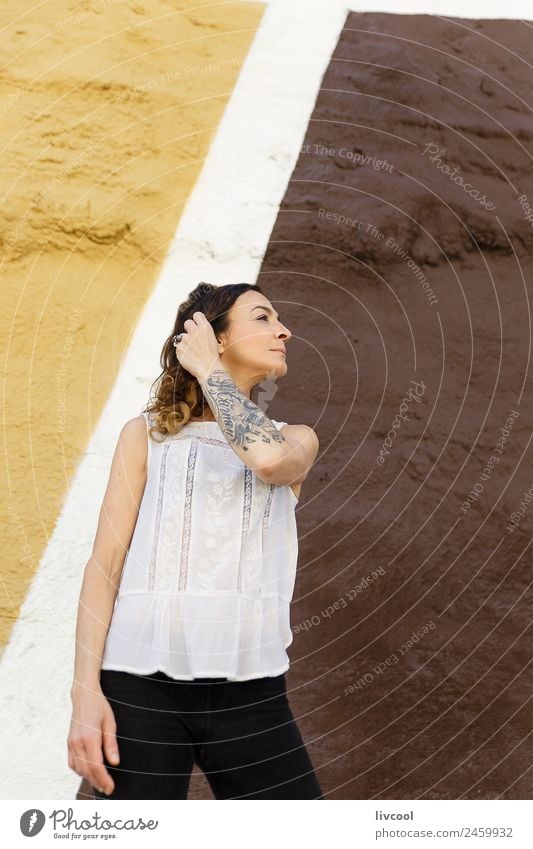 Tattooed woman in front of a wall Lifestyle Happy Beautiful Face Relaxation Calm Human being Feminine Woman Adults Body 45 - 60 years Art Building Facade Street