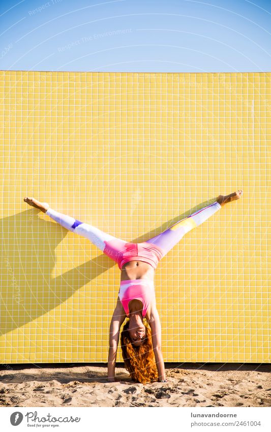 Woman doing a handstand on the beach Lifestyle Sports Fitness Sports Training Yoga Young woman Youth (Young adults) Adults Red-haired Thin Happiness Healthy