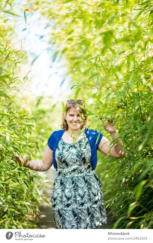 Portrait of a young woman in the bamboo jungle Portrait photograph Young woman 1 Person Woman Feminine Blonde Green Nature Day Bamboo Bushes Leaf Forest