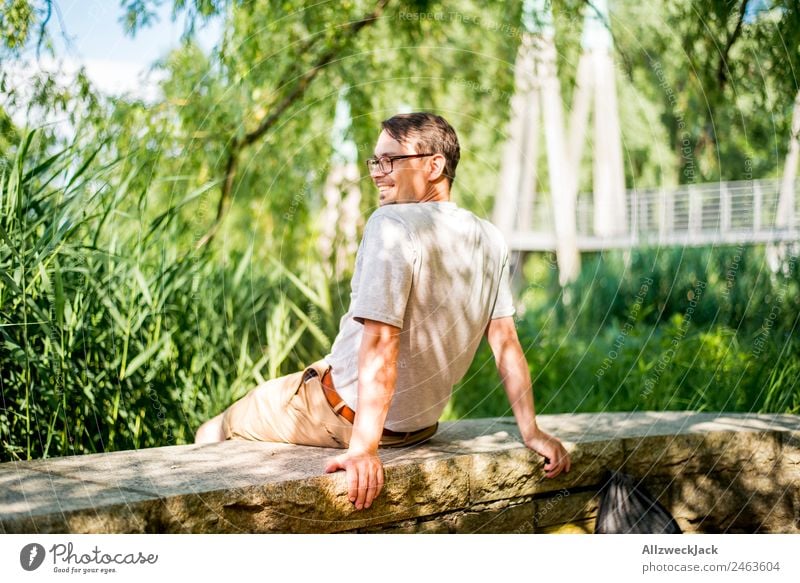 Portrait of a young man in nature Portrait photograph Young man 1 Person Eyeglasses Green Nature Day Sit Relaxation Break Restful To enjoy Park