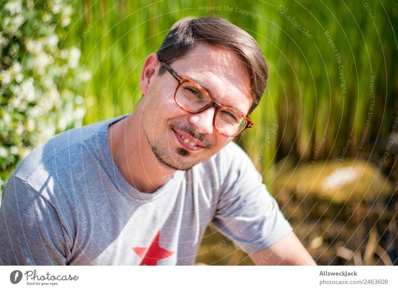 young man with glasses smiles in camera 1 Person Young man Portrait photograph Eyeglasses Person wearing glasses Smiling Congenial Happiness Friendliness Nature