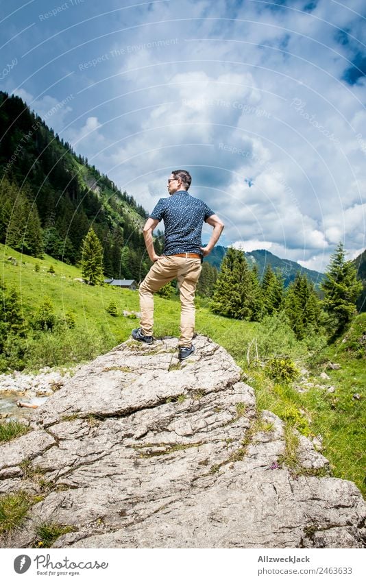 young man posing on a rock in front of a mountain panorama Day Beautiful weather Clouds Nature Green Tree Forest Mountain Idyll Vacation & Travel