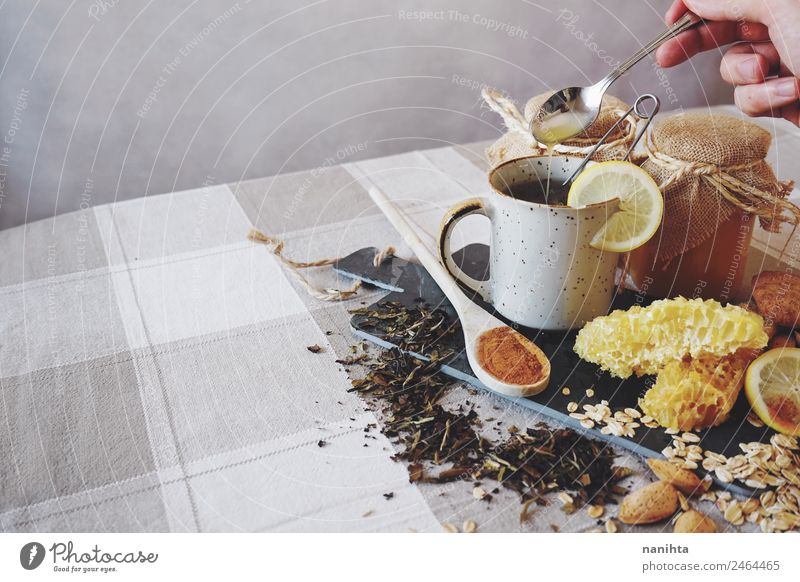 Healthy breakfast against common cold Grain Herbs and spices Almond Honey Honey-comb Cinnamon Lemon Oats Oat flakes Beverage Hot drink Tea Cup Spoon