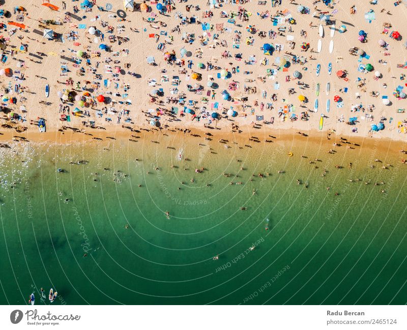 Aerial View From Flying Drone Of People Crowd Relaxing On Algarve Beach In Portugal Aircraft Vantage point Sand Background picture Water Above Ocean