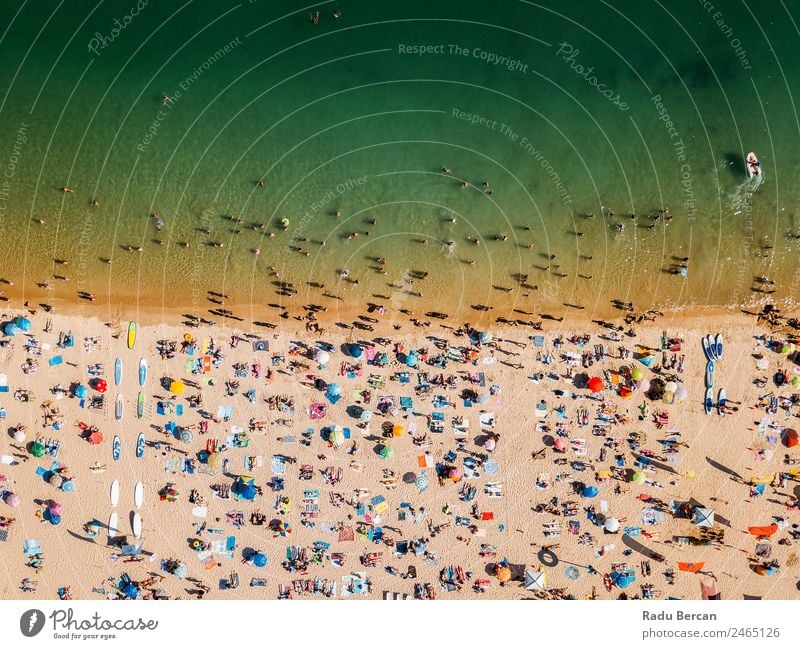 Aerial View From Flying Drone Of People Crowd Relaxing On Algarve Beach In Portugal Aircraft Vantage point Sand Background picture Water Above Ocean