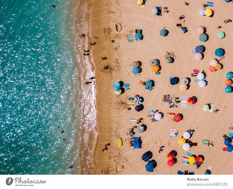 Aerial View From Flying Drone Of People Crowd Relaxing On Algarve Beach In Portugal Aircraft Vantage point Sand Background picture Water Above Ocean