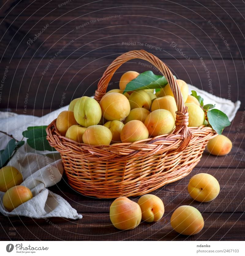 apricots in a brown wicker basket Fruit Nutrition Vegetarian diet Diet Table Nature Leaf Wood Fresh Delicious Natural Juicy Brown Yellow Colour Basket