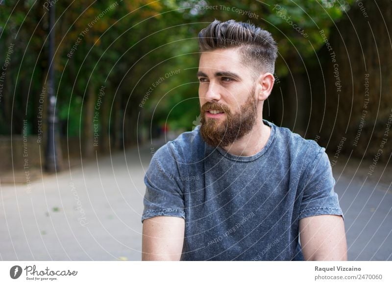 Man sitting outdoors in spring Human being Masculine Young man Youth (Young adults) Head Face Bottom 1 18 - 30 years Adults Park T-shirt Blonde Beard Catch