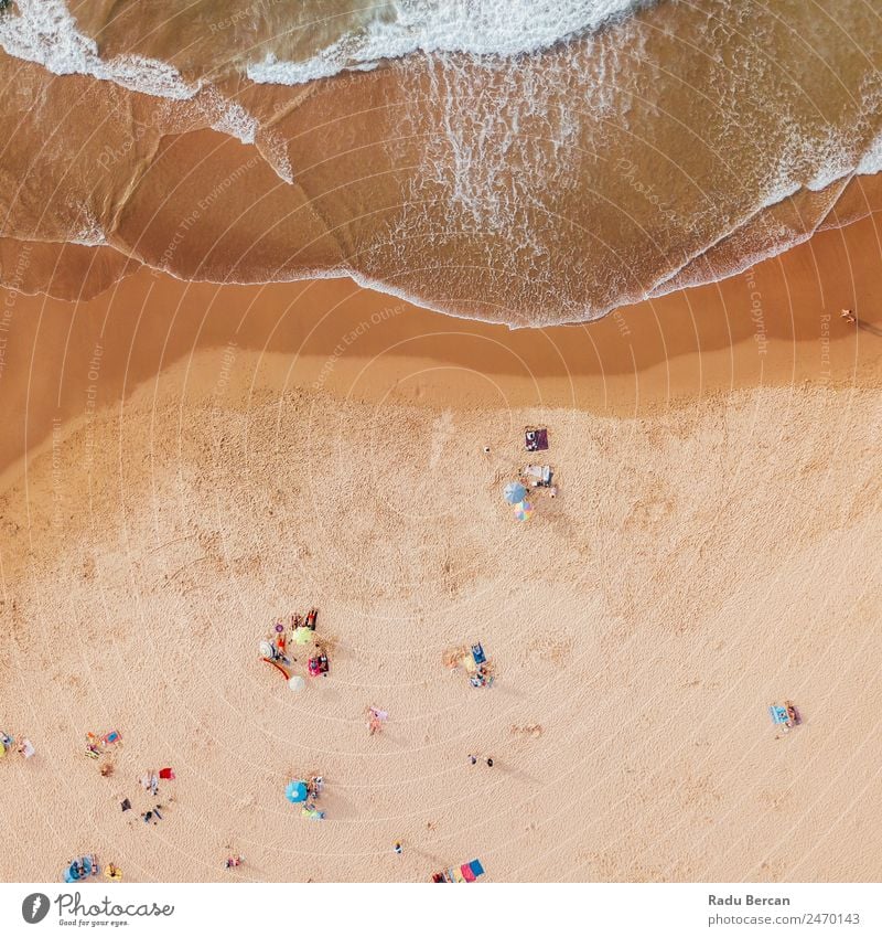 Aerial View From Flying Drone Of People Crowd Relaxing On Algarve Beach In Portugal Aircraft Vantage point Sand Background picture Water Above Ocean