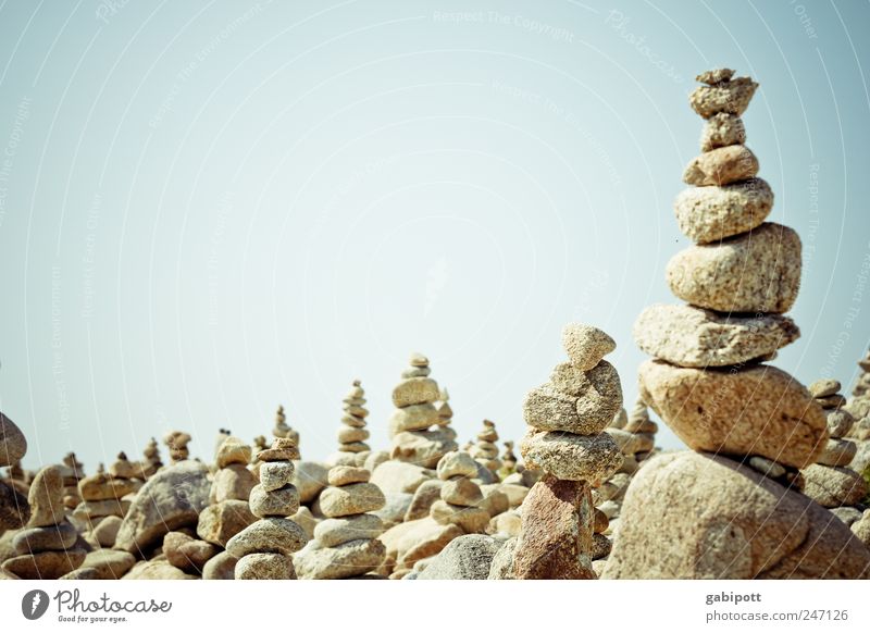 another stack of stones Leisure and hobbies Playing Landscape Sky Summer Beautiful weather Stone Bright Blue Brown Attentive Serene Patient Contentment Planning