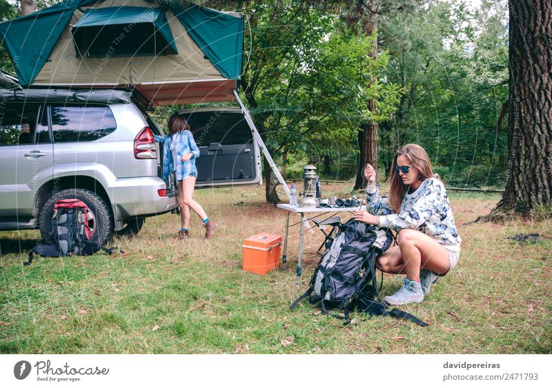 Woman preparing backpack for a hiking trip Lifestyle Joy Happy Leisure and hobbies Vacation & Travel Trip Adventure Camping Summer Mountain Hiking Sports